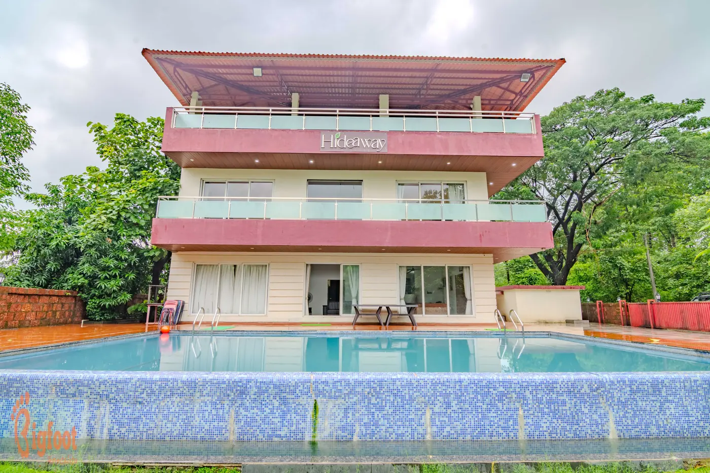 Hideaway Villa in Karjat with its swimming pool and garden in the foreground