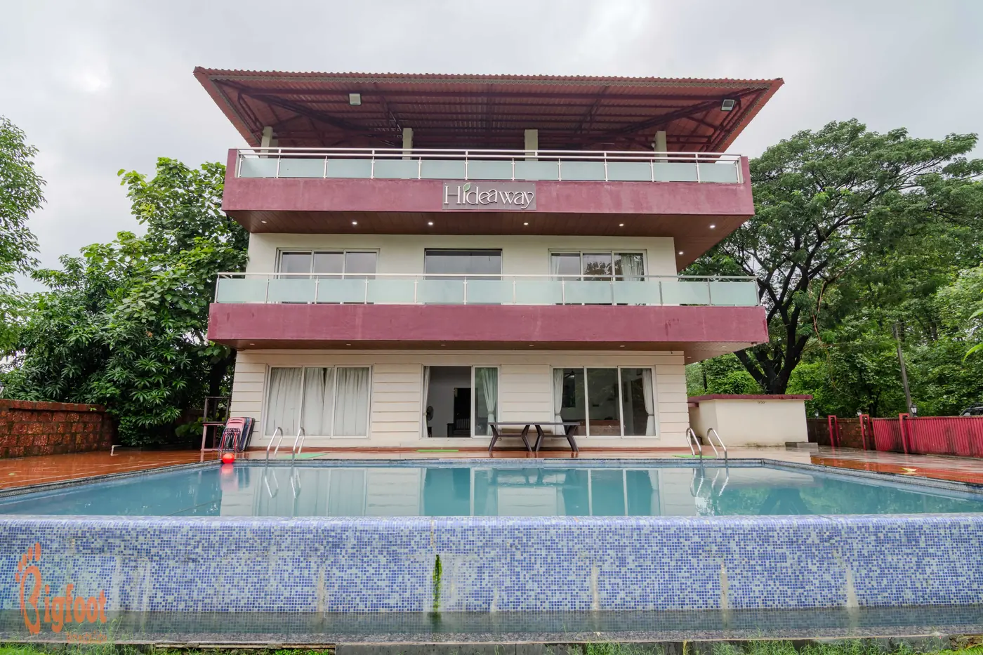 The front elevation of Hideaway Villa in Karjat with its pool and garden