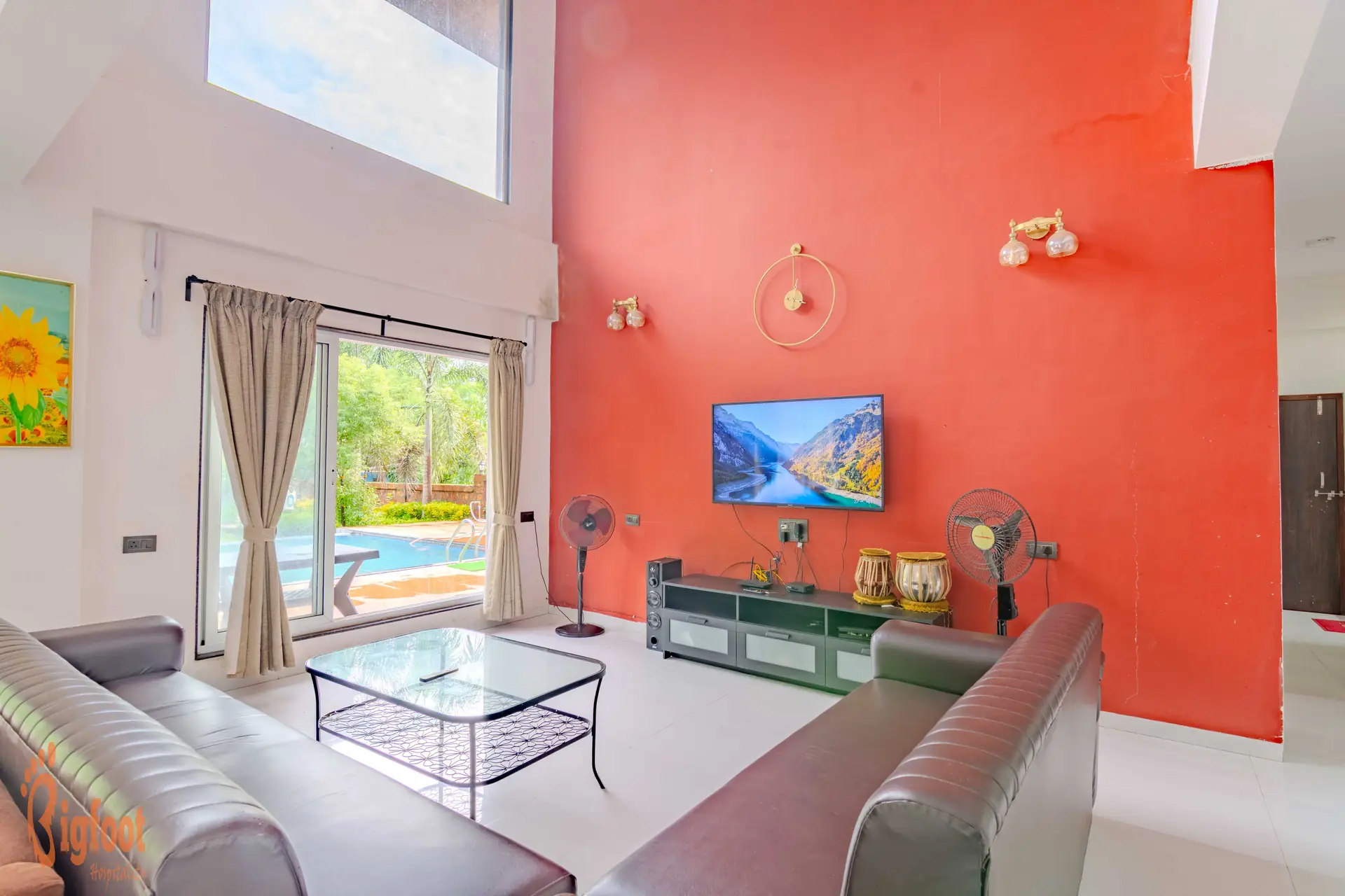 Double-height living hall at Hideaway Villa with garden and pool views
