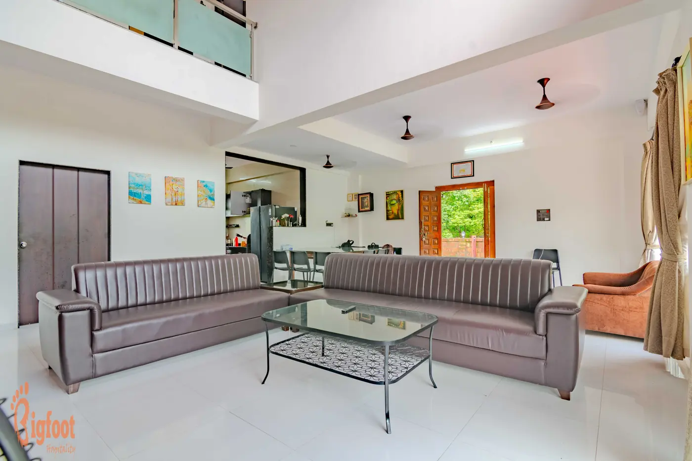 Living hall at Hideaway Villa with sofas and a glass coffee table