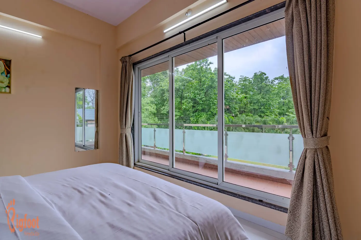 Air-conditioned bedroom at Hideaway Villa with a sliding door leading onto the balcony