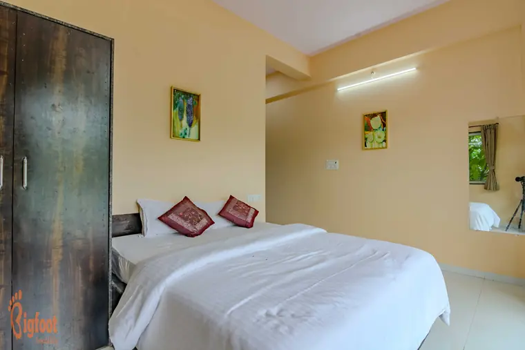 Bedroom at Hideaway Villa with a mirror and sitting corner